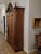 This 19th-century American Rococo Revival walnut and burl armoire is a grand Victorian-era wardrobe. It features deep,...