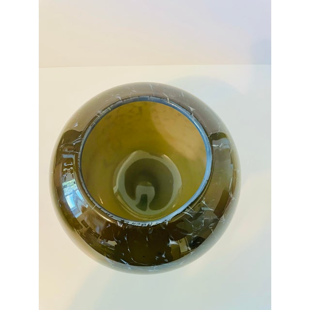 Add a touch of retro sophistication to your home decor with this gorgeous, vintage hand-blown glass globe vase. This...