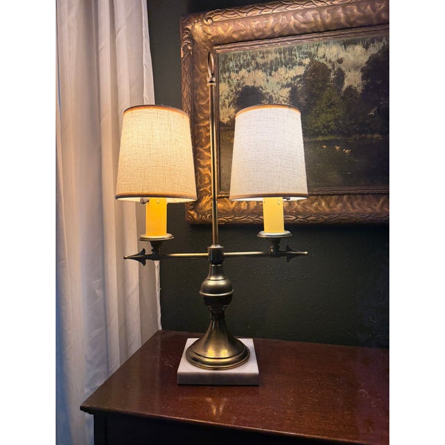 Bring classic French elegance to your space with this stunning two-light brass and marble bouillotte-style table lamp....
