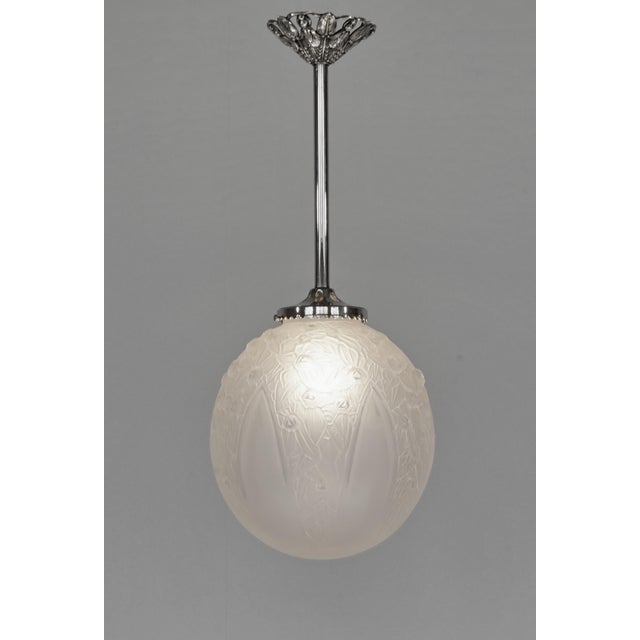 André Delatte A wonderful 1925-30 French art deco pendant in nickel plated bronze or solid brass holding a large globe in...