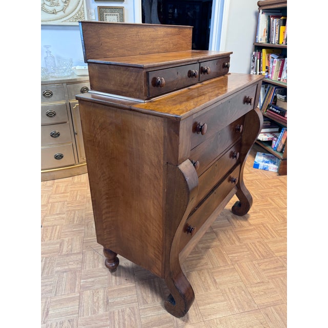 A handsome American Late Classical (Empire) chest of drawers, circa 1835–1850, in the pillar-and-scroll form. The drawer...