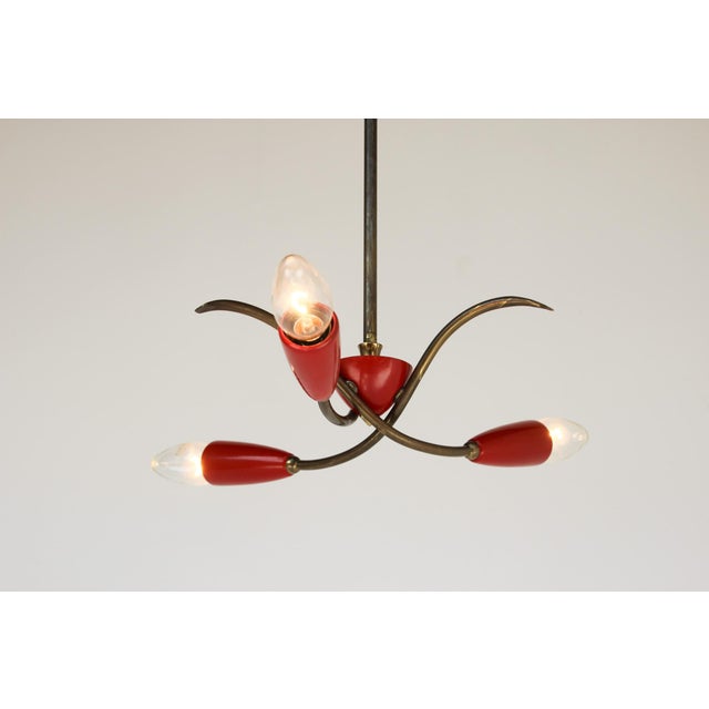 Beautiful modernist lamp, made in Italy in the 1950s. Brass and red lacquered sheet metal. Very good original condition....