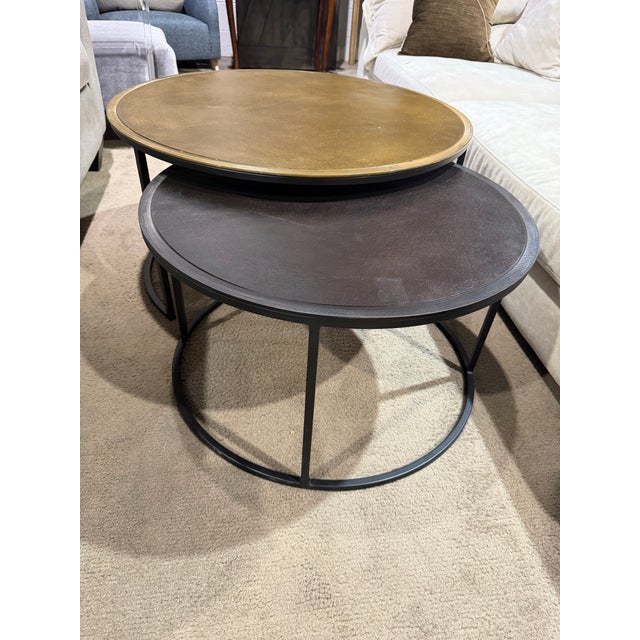 Introduce effortless versatility and modern style to your living space with the Crate & Barrel “Duke” nesting coffee table...