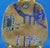 Tem description: stoneware plate entirely hand-modeled and decorated with glazes featuring archaic rural figures in a...