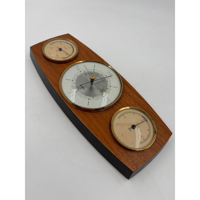 Analog weather station with barometer (center) and two smaller instruments (left/right) in a horizontal wooden case with...