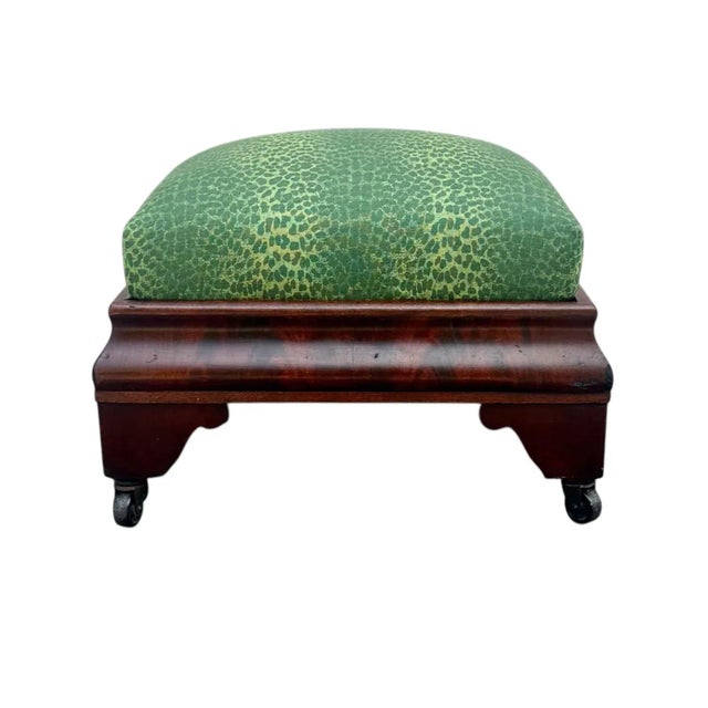 A beautiful large mahogany veneer stool, likely American, dating to around 1840. The stool rests on charming celluloid...