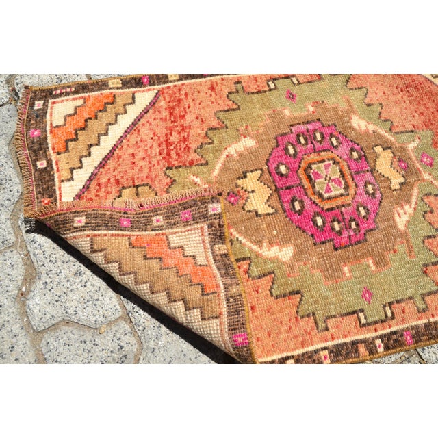 This is a vintage Turkish Oushak rug from the 1960s. The piece was hand-knotted.