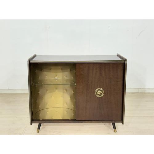 Stylish mid-century bar cabinet from the 1960s with an integrated record player. The piece impresses with its compact...