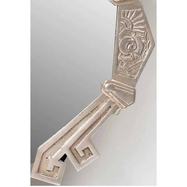 Art Deco wall mirror with a silvered bronze frame, early 20th century. The frame has the clean geometric lines...