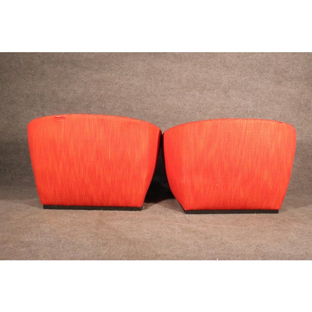 Pair of vintage style club chairs with red upholstery. Fun round saucer shape.
