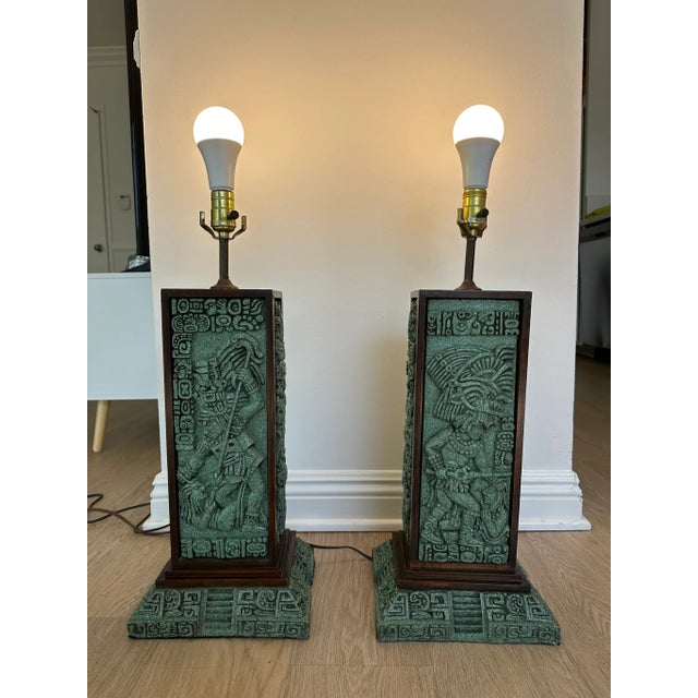 Pair of mid-century modern Zarebski table lamps. Lamps have intricate Mayan design made of malachite, framed in mahogany....