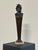 Bronze bust depicting a satyr, characterized by a marked theatrical and grotesque expressiveness. The face features a...