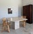 Rhombus Form Travertine Dining Table attributed to circa 1980s Italian production by Stone International. 69.5" measured...