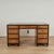 Impressive vintage campaign style desk crafted in satinwood with ebonized trim, featuring three tooled leather panels on...