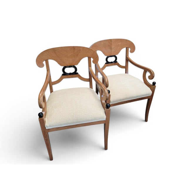 This pair of Biedermeier-style armchairs blend the architectural aesthetic of Neoclassicism with the decorative...