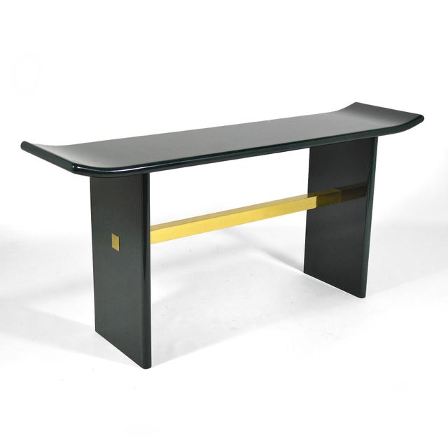 A substantial and striking piece, this console table clad in faux malachite has a form which is reminiscent of the...