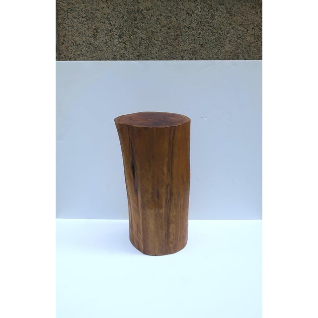 A natural wood pedestal side drinks table, in the Organic Modern style, circa late‑20th century. A rich brown natural wood...