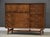 A mid century modern walnut eight drawer dresser credenza with swooping walnut and brass arch details made by Broyhill...