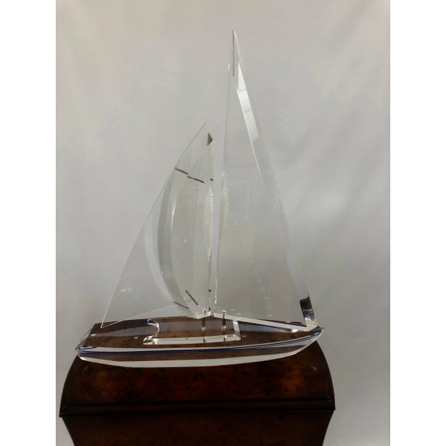 Sleek Lucite sculpture of a sailboat, signed and numbered 362/500 by Eugene Brignola. The sails move and the hull is...
