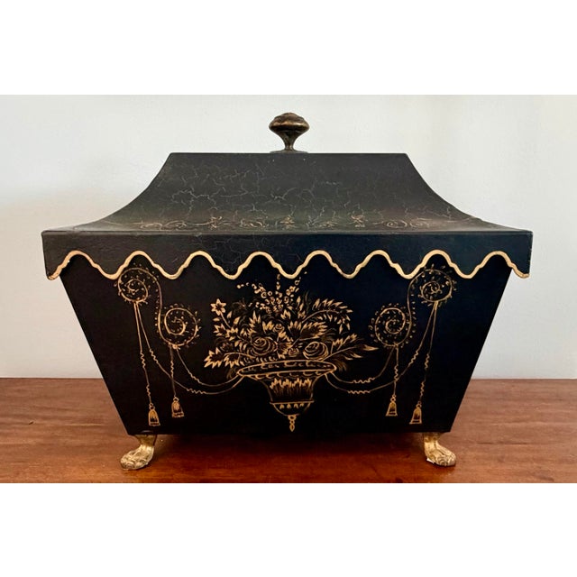 Decorative black tole footed box with scalloped edge and rim handles. Lovely chinoiserie decoration by Sarreid.