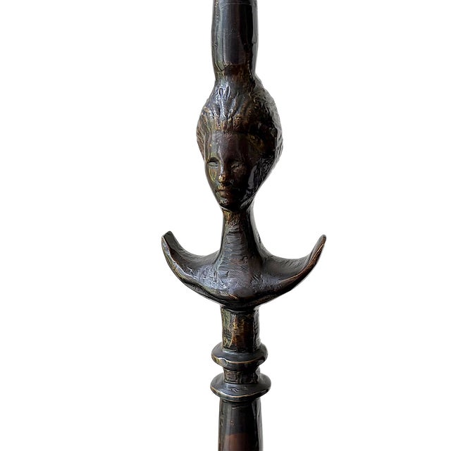 Hand-finished variegated cast metal table lamp in the style of Giacometti. Flared circular base rises into a stylized...