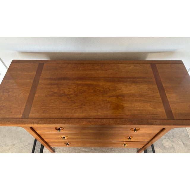 The Drexel MCM Winged Walnut Chest from the "Counterpoint" Collection by John Van Koert is a stylish and modern sideboard...