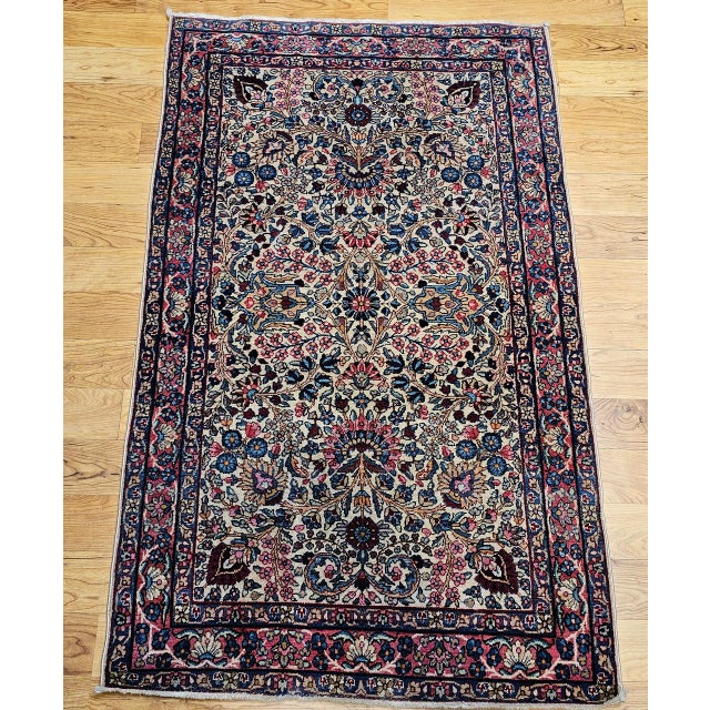 "Vintage Persian Kerman Lavar area rug in an all over pattern set on an ivory color background. This piece is a...
