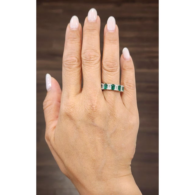 A natural emerald-cut Colombian emerald and diamond eternity band is a stunning and timeless piece of jewelry, perfect for...