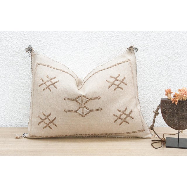 Introduce a touch of earthy elegance with our handcrafted lumbar/rectangular Moroccan cactus silk pillow. Woven from the...
