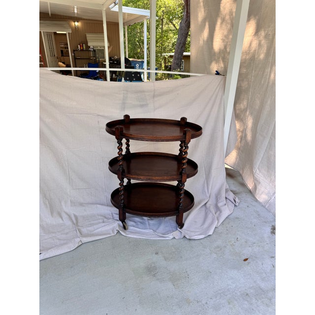 This English barley twist side bar cart with oval tired top is perfect for any room that needs a very unique piece! It...