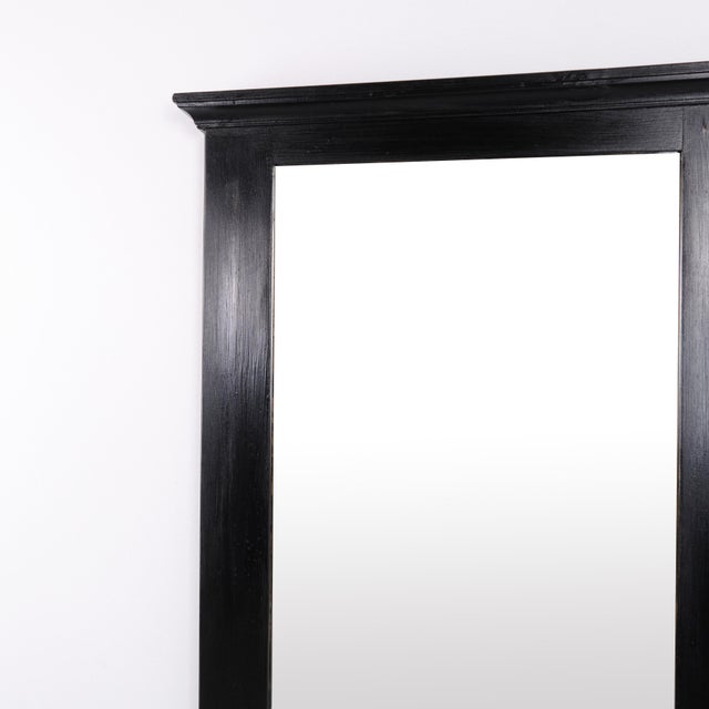 Mirror with a black-painted pine frame dating from the 1940s. It features a simple and timeless design suitable for both...