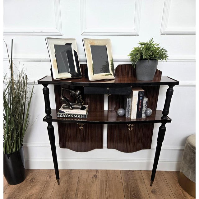 Very elegant and refined Italian 1960s Mid-Century Modern and Art Deco design console table. Standing on beautifully...