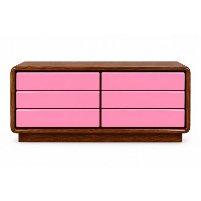 This postmodern dresser brings a bold splash of color to a sculptural, low-profile design. Six smooth drawer fronts in a...