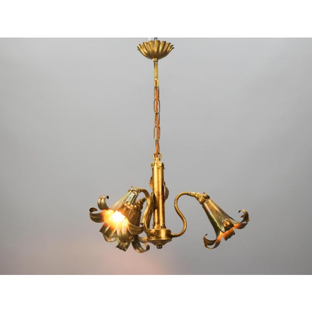 A beautiful and very unusual Hollywood Regency-style chandelier attributed to Hans Kögl. This adorable gilt metal flower-...