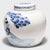 Loosely brushed with cobalt blue pigments, this round, blue-and-white storage jar is underglazed with a celebratory...