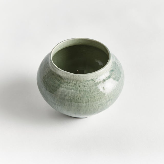 In a modern silhouette with a subtle linenlike texture, reactive glaze and high gloss finish, this ceramic pot is a...