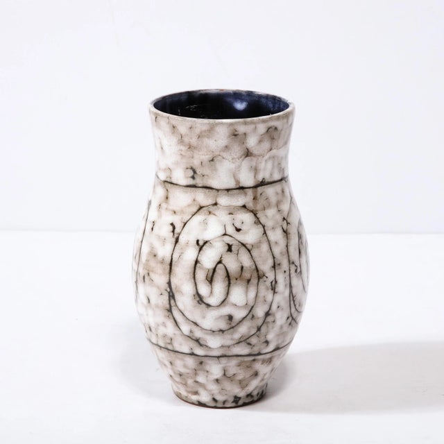 This Mid-Century Modernist Ceramic Vase W/ Coiled Motif is a beautiful example of Post War European Ceramics, realized in...