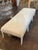 This 19th century Swedish Gustavian carved and whitewashed bench exudes a sense of vintage charm and elegance. With...