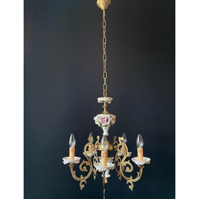 The italian chandelier is made of brass. Impeccable artistic forging. The chandelier is adorned with floral-style...