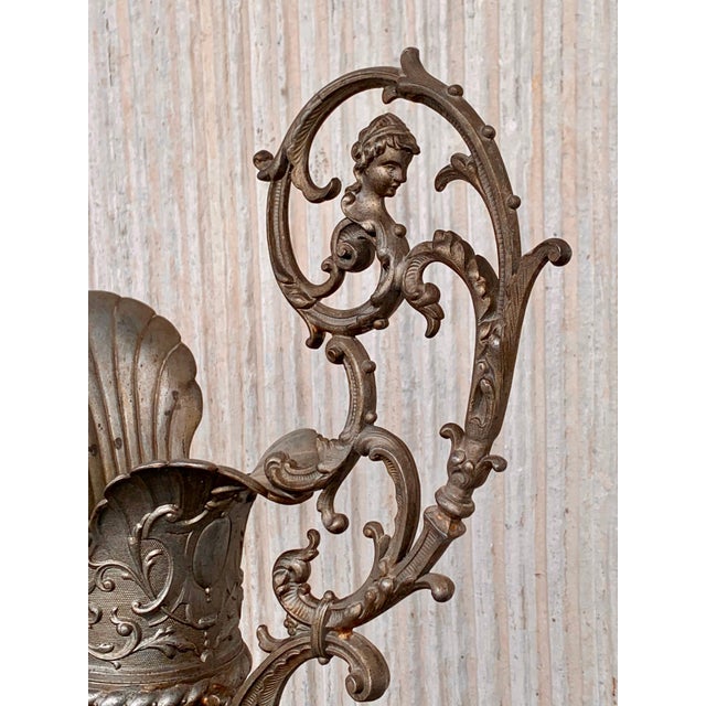 Pair of Sevres ewer-form mantel decorations, 19th century, hand-painted with scenes front and back, bronze mounts with...