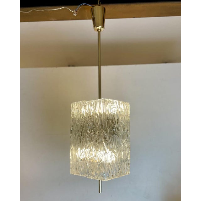 Beautiful mid-century chandelier, pendant lamp made of a brass base with two glass-molded lampshades. Designed in vienna...