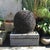 Beautiful modern fountain crafted of rounded river stone pebbles framed to a sphere that sits on top of a matching base /...