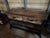 Handsome industrial console made of black iron and reclaimed wood having two drawers, two lower shelves, black casters,...