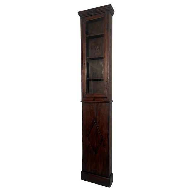 This rare italian wall-mounted cabinet, handcrafted in solid chestnut wood during the late 18th century, is an exceptional...
