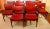 1970s set of 10 mid century modern side chairs, English. Teak with original red vinyl upholstered backs & seats. Stylishly...