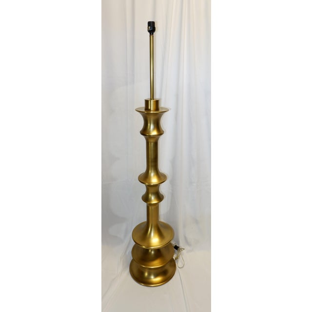 Unique out of production Waldo floor lamp. Large-scale metallic spindle floor lamp in an antique brass finish has a...