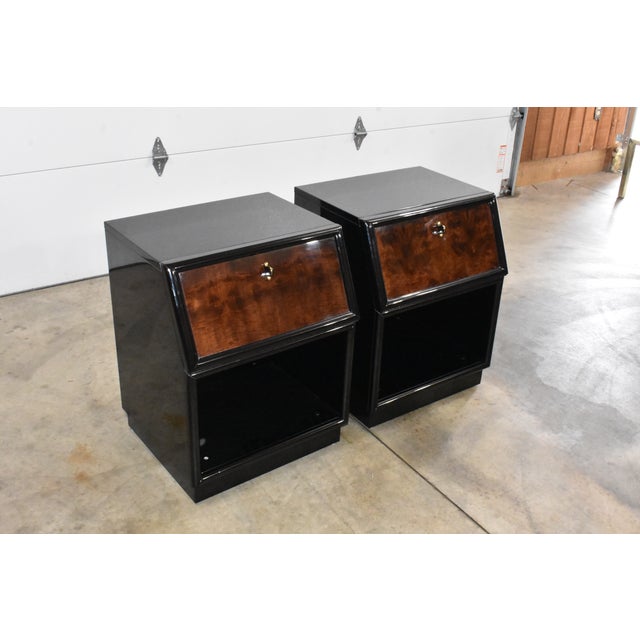 Terrific pair of black lacquer and burl walnut nightstands made by Henredon from their Scene Three collection. Each has 1...