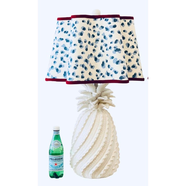 Pair matching Ivory, ceramic table lamps featuring a raised, twisted design with leaves at the top that resemble...