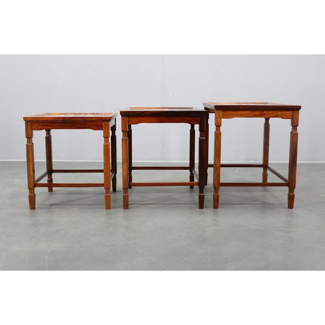 Beautiful set of three 1960s danish nesting tables crafted from solid wood and featuring hand-painted ceramic tile tops...