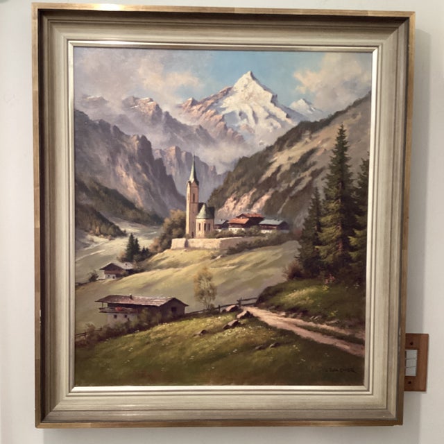 The product is a vintage oil painting of an Alpine church landscape by Austrian artist Othmar Wagner. This original mid...